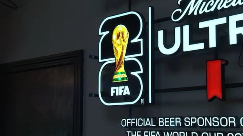 A neon FIFA 2026 sign glows at Buffalo State Pizza in Kansas City, where owner Philippe...