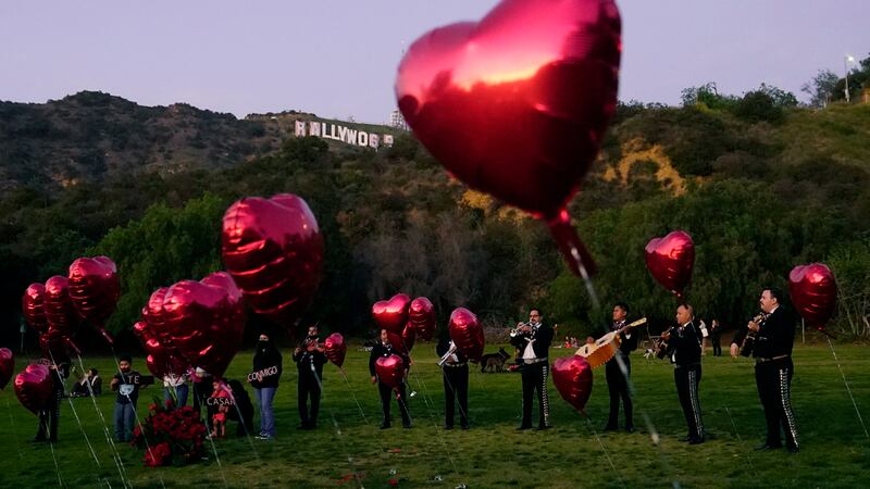 Una banda de mariachis espera a que comience una ceremonia de pedido de matrimonio en Lake...