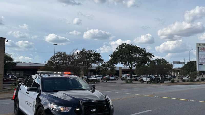 In this photo taken with a smart phone Police block a street after a shooting involving an ICE...