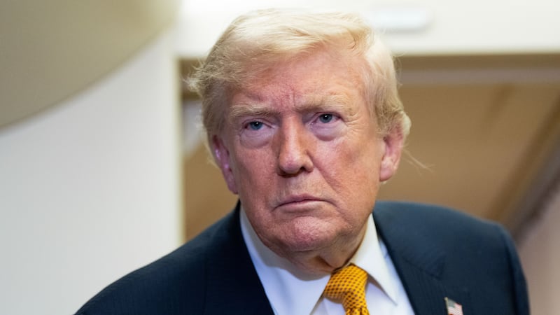 President Donald Trump speaks with reporters in flight on Air Force One after landing at U.S....