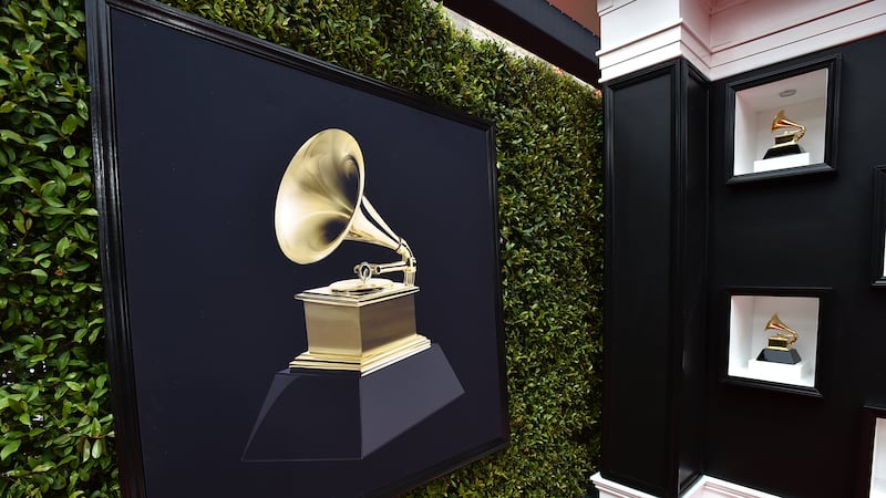FILE - Decorative Grammy Awards appear on the red carpet at the 64th annual Grammy Awards in...