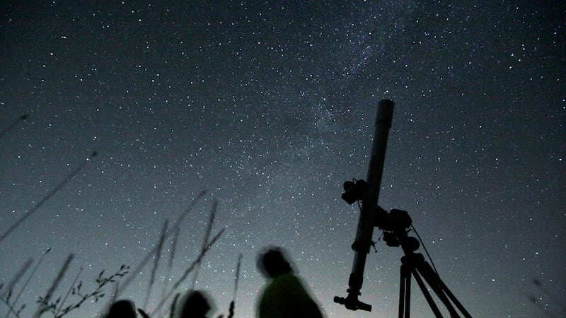 ARCHIVO - Unas personas observan el cielo en un observatorio cerca de la capital búlgara de...