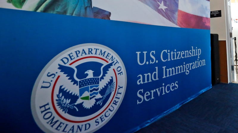 FILE - People arrive before the start of a naturalization ceremony at the U.S. Citizenship and...