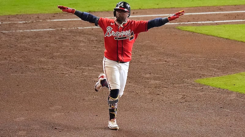Atlanta Braves' Ozzie Albies celebrates his two-run home run against the Philadelphia Phillies...