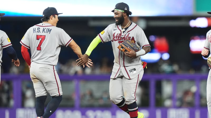 Atlanta Braves' Ha-Seong Kim (7) and Michael Harris II, right, celebrate after the Braves...