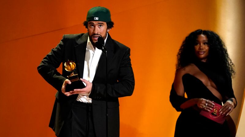 Bad Bunny, izquierda, recibe el premio a mejor álbum de música urbana  por "Un verano sin ti"...