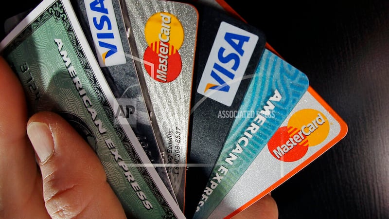 FILE - Consumer credit cards are posed in North Andover, Mass., March 5, 2012. The Consumer...