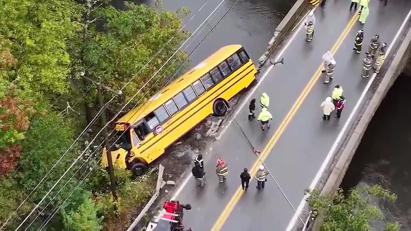 A school bus crashed through a bridge and hung over a river in Northbridge, Massachusetts,...