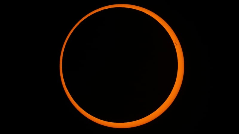 FILE - The moon moves across the sun during a "ring of fire" annular solar eclipse seen from...