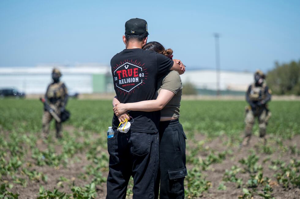 Arturo Rangel abraza a Judith Ramos cuyo padre trabaja en un invernadero en el fondo, mientras...
