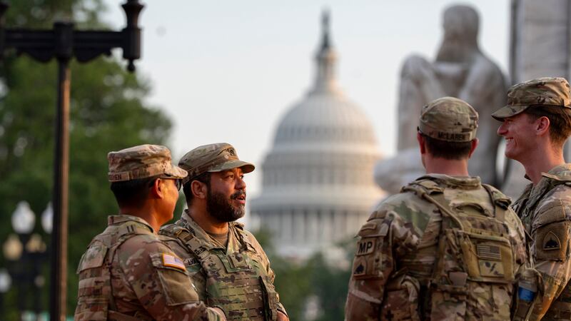 Soldados de la Guardia Nacional del Distrito de Columbia conversan en la Estación Union, con...