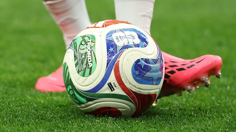 An official ball is played during warms ups before the World Cup round of 32 soccer match...