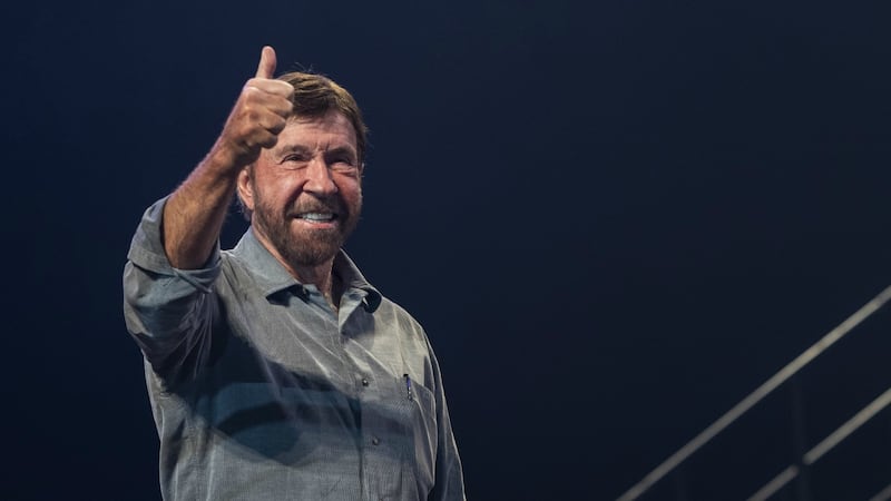 US actor and martial artist Chuck Norris, this year's special guest signals to the audience...