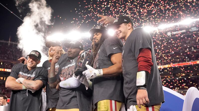 El corredor de los 49ers de San Francisc Christian McCaffrey celebra con el tight end George...