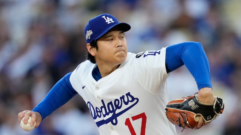 Los Angeles Dodgers pitcher Shohei Ohtani throws against the Milwaukee Brewers during the...