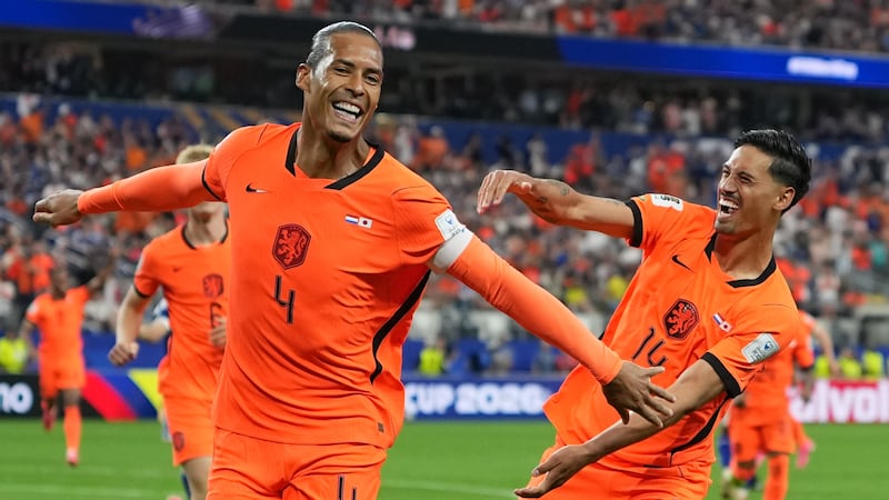 Netherlands' Virgil van Dijk (4) celebrates scoring his side's first goal against Japan during...