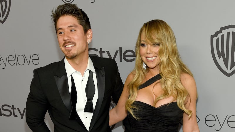 ARCHIVO - Bryan Tanaka, izquierda, y Mariah Carey llegan a la fiesta posterior a los Globos de...