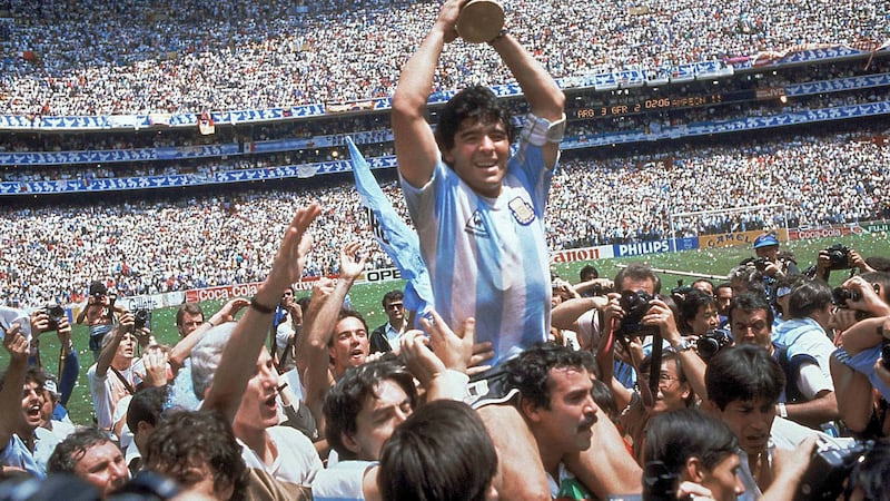 FILE - In this June 29, 1986 file photo, Diego Maradona holds up the trophy after Argentina...