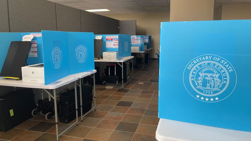 Voting machines await in-person voters in a race that will decide who replaces former...