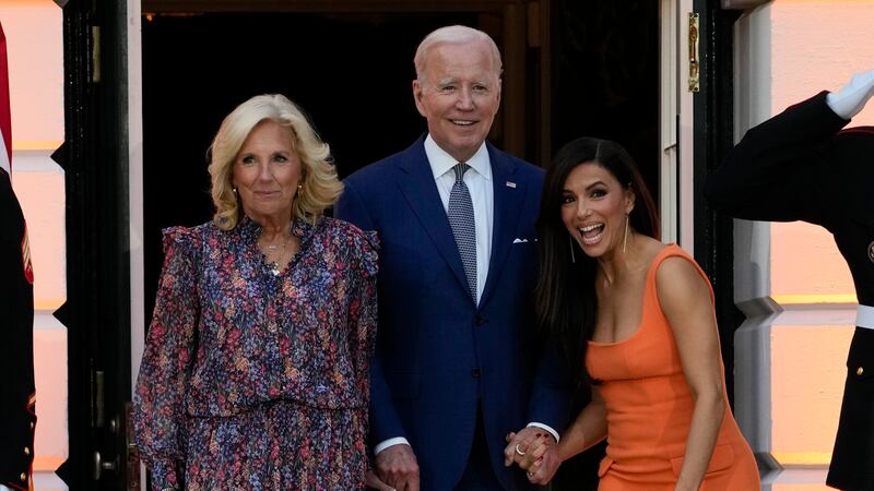 El presidente Joe Biden camina con la primera dama Jill Biden y Eva Longoria para dar unas...
