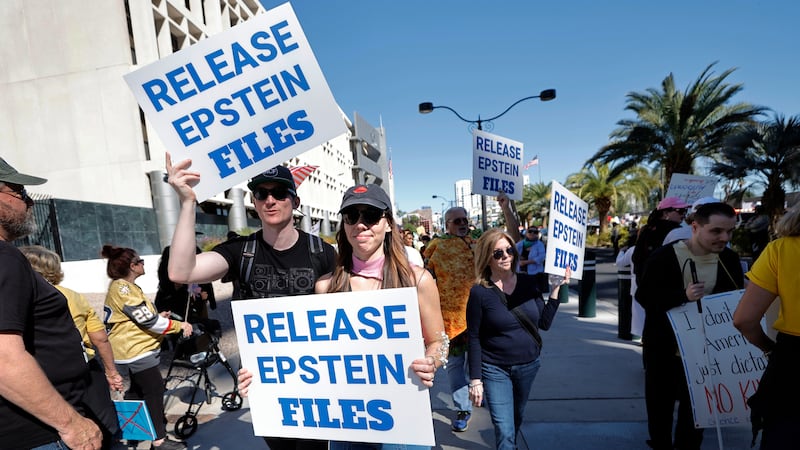 Manifestantes sostienen carteles donde exigen la divulgación de los archivos de Epstein...