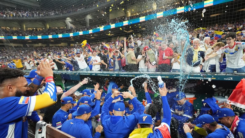 The Venezuela team celebrates after defeating Italy at a World Baseball Classic semifinal...