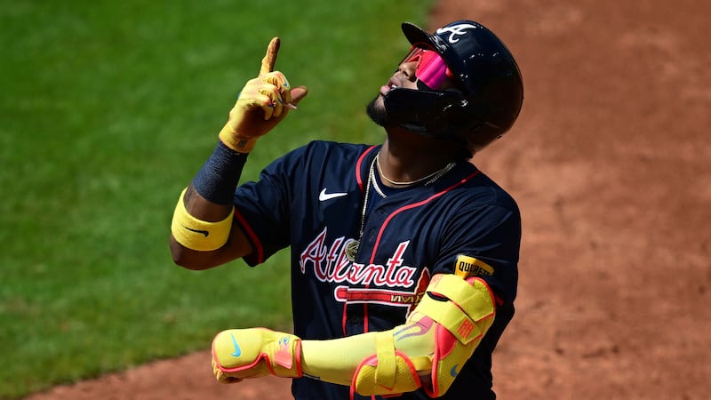 Atlanta Braves' Ronald Acuna Jr. celebrates after hitting a single during the third inning of...