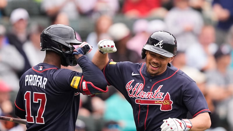 Atlanta Braves Drake Baldwin is greeted by Jurickson Profar after hitting a solo home run in...