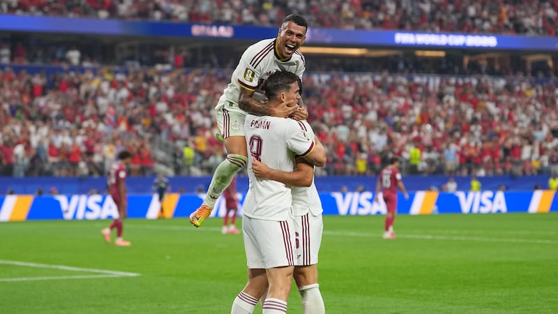 Spain's Pedro Porro, top, congrats Spain's Mikel Merino, right, after scored during the World...