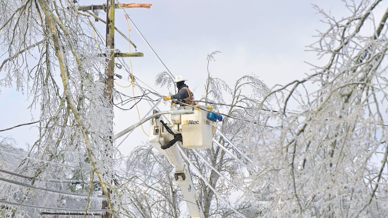 A lineman works to restore power in Oxford, Miss. on Monday, Jan. 26, 2026, following a...