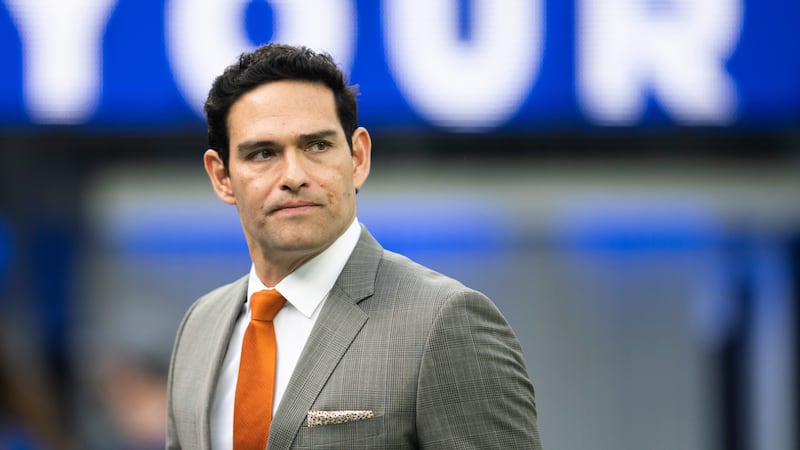 Mark Sanchez walks on the field before an NFL football game between the Los Angeles Rams and...