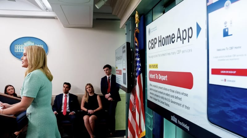 A monitor displays a new U.S. Customs and Border Protection app with "a self-deportation...