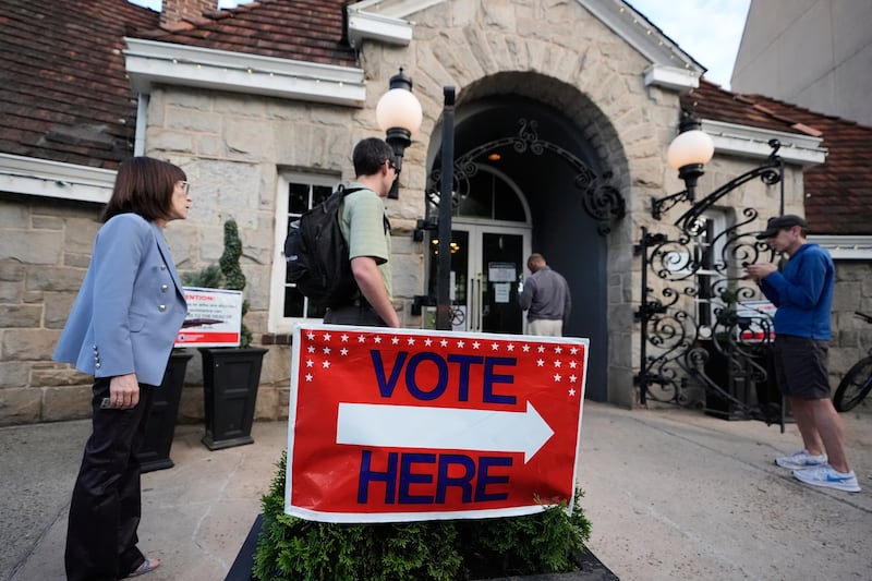 People wait in a line at a precinct before voting during a Georgia primary on Tuesday, May 19,...